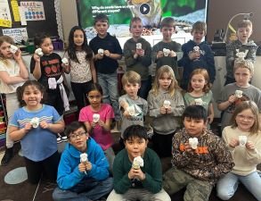 MAES 2nd graders show off their seeds they planted with the help of WCROC staff.